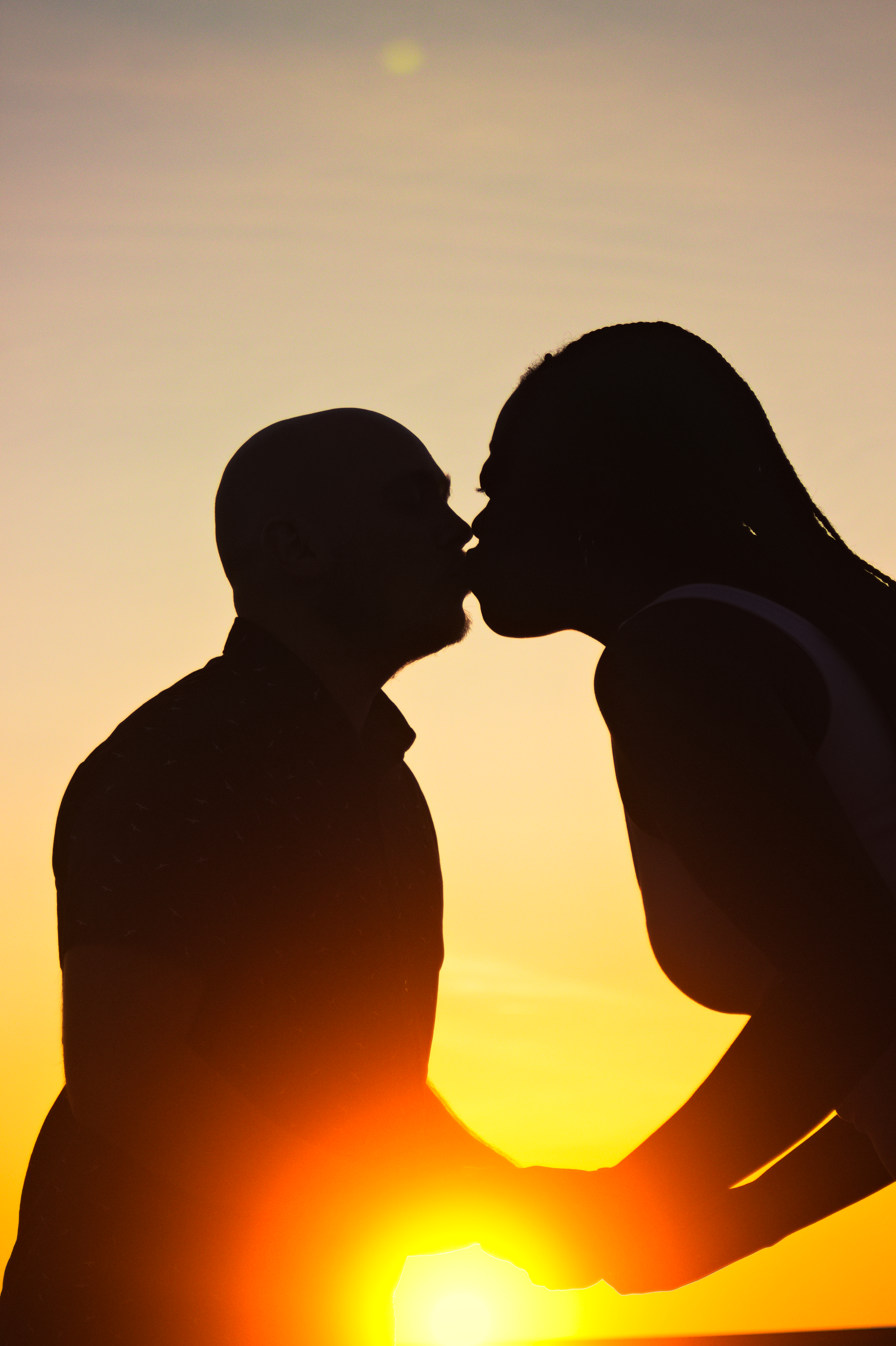 Couple kiss silhouette sunset