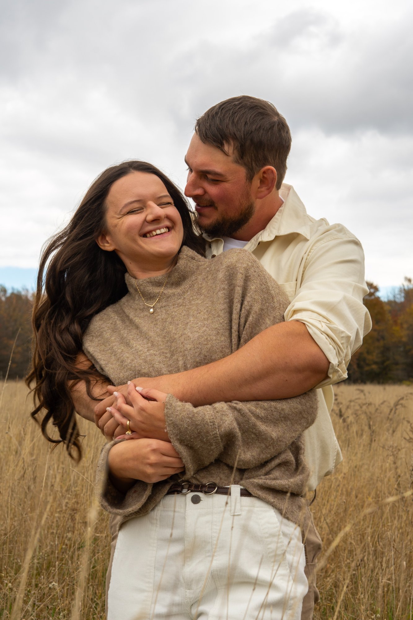 Couple embracing field