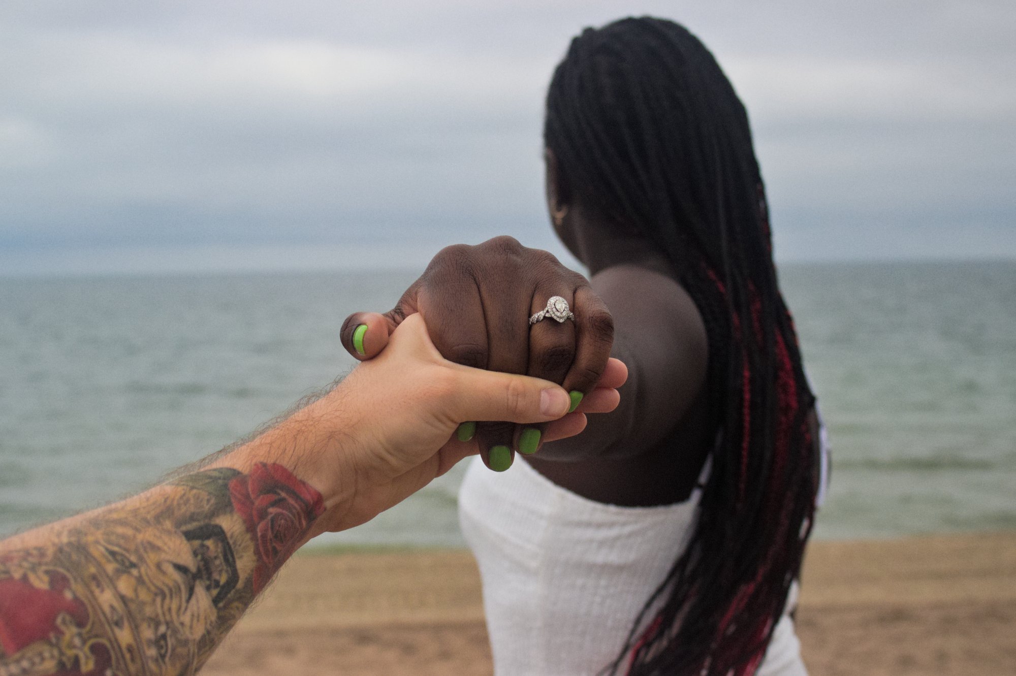 Couple holding hands beach
